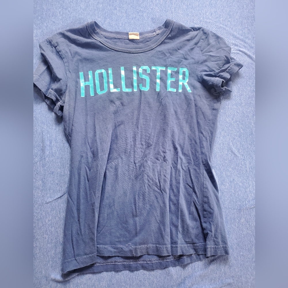 Blue Hollister t-shirt with Teazers Beauty School on back. Size medium.